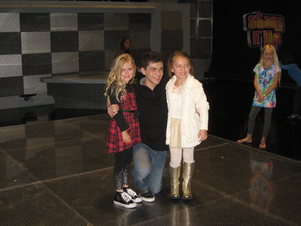 Nov. 2010: Emily and Caitlin with Adam Irigoyen on the set of Disney's Shake It Up! Emily's sister, Lauren, smiling and looking on...