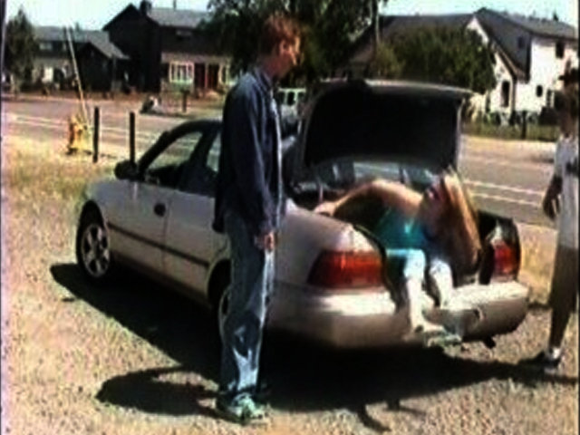 Cody and Chris open the trunk of the car to find Brittany sneaking along with them.