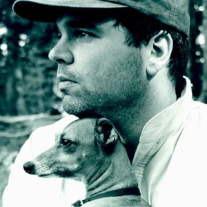 Clay Luther, on a mountain, with a dog