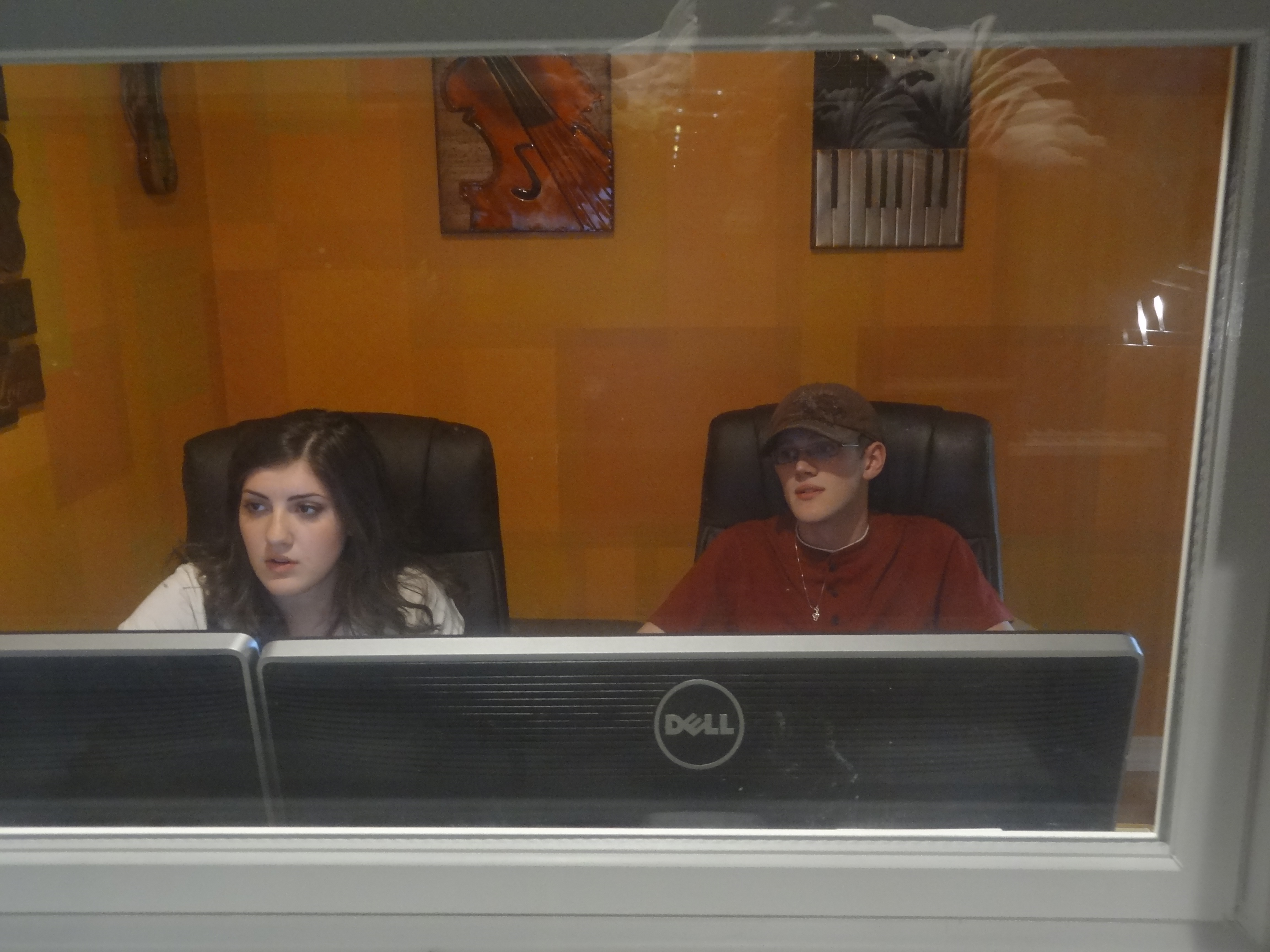 Shot from inside the sound booth shows the exhausted pair, Sound Engineer Mary Rose Maher, and Composer, Nate Weil working hard into the night to meet the deadline.