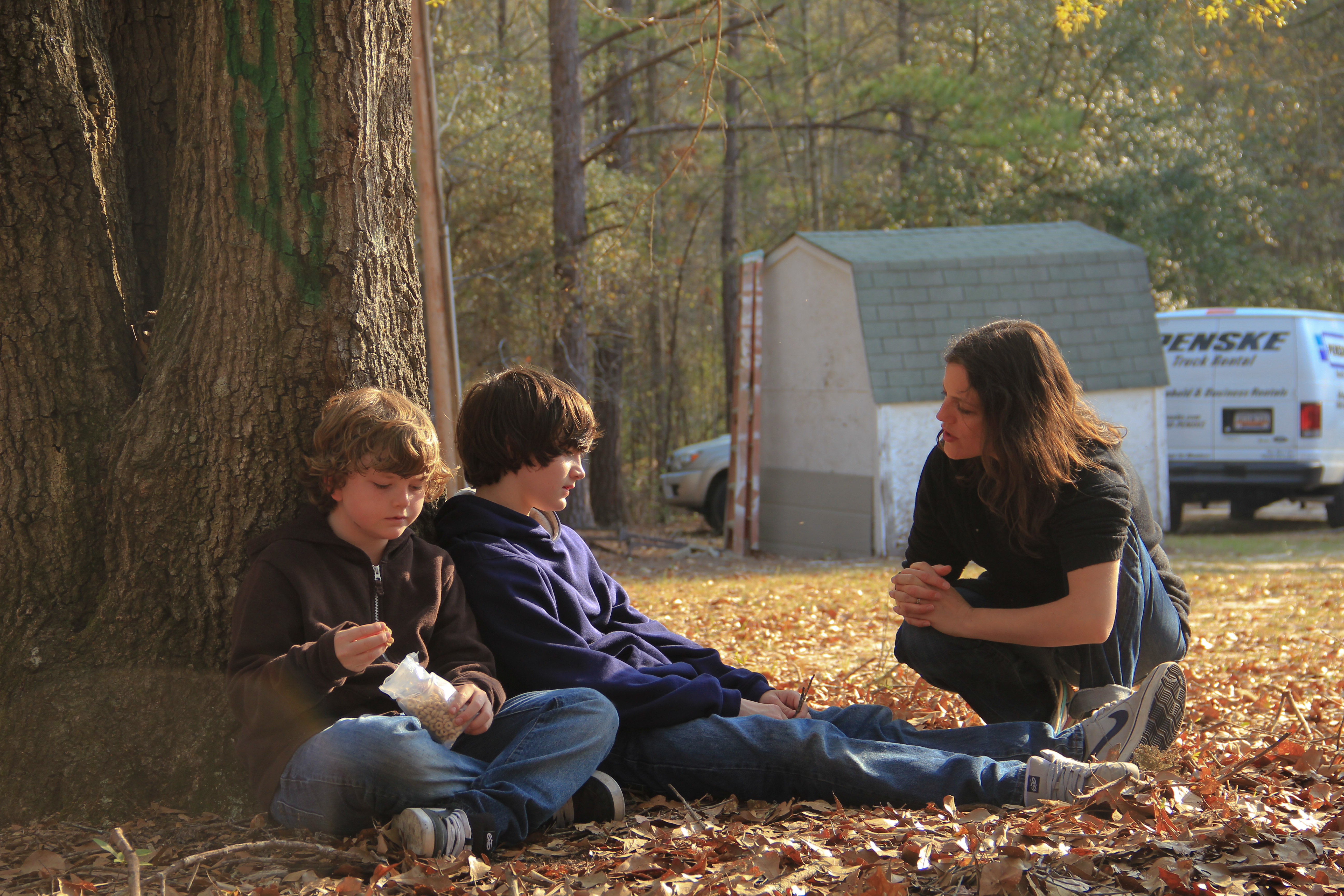 Director Emilie McDonald speaking to actors Landon Williams & Tyler Williams during the CROSSING THE RIVER shoot