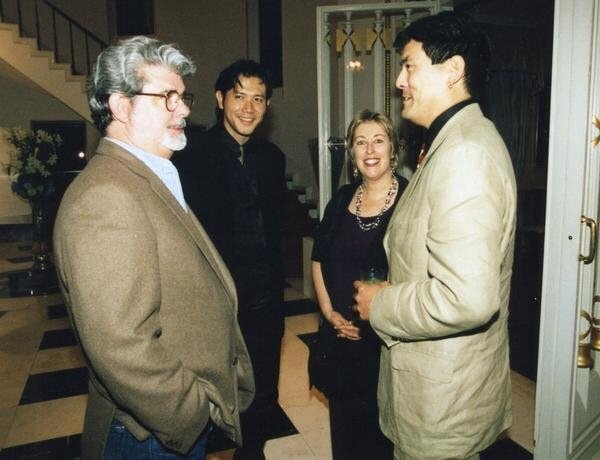 1st American Short Shorts Film Festival: (l-r) George Lucas, festival director Tetsuya Bessho, festival staff Helen Zeilberger, filmmaker Chris Tashima - June 1999; reception at U.S. Embassy, Tokyo, Japan