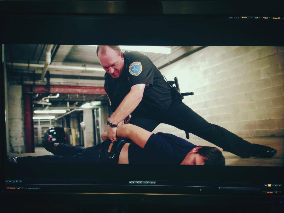 Screen grab of takedown/handcuff scene from Tragedy