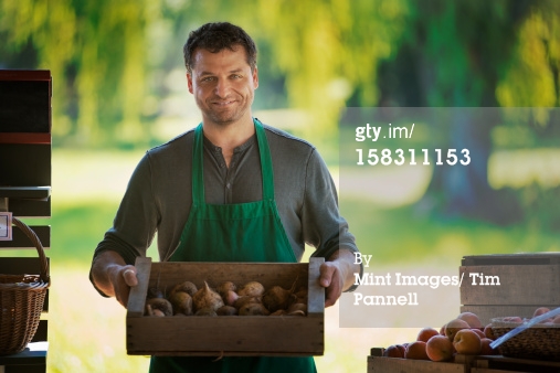 http://www.gettyimages.com/detail/photo/man-with-a-box-of-freshly-picked-fruit-royalty-free-image/158311153