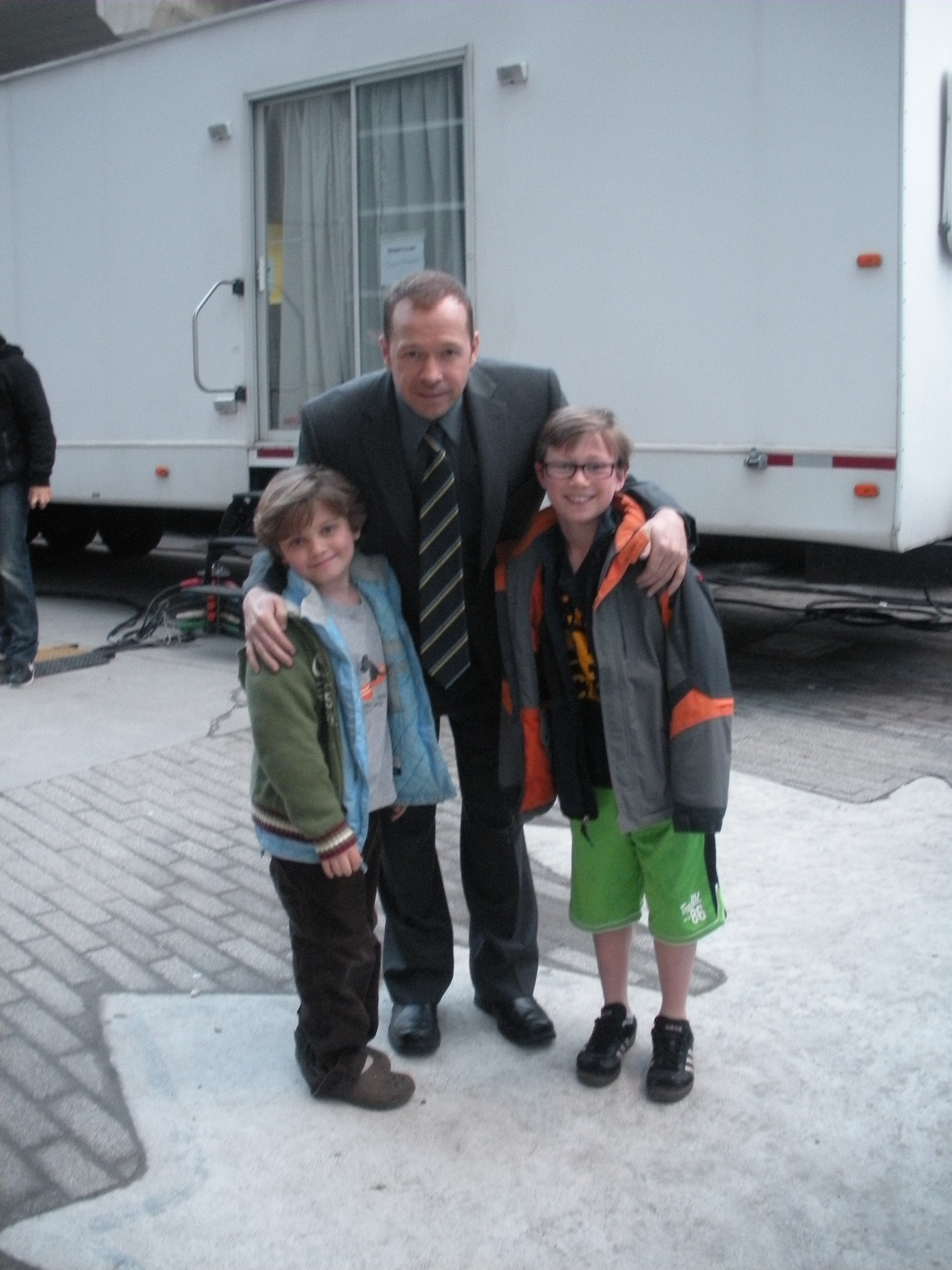 Tony Terraciano with his brother Andrew and Donnie Wahlberg on the set of Blue Bloods.