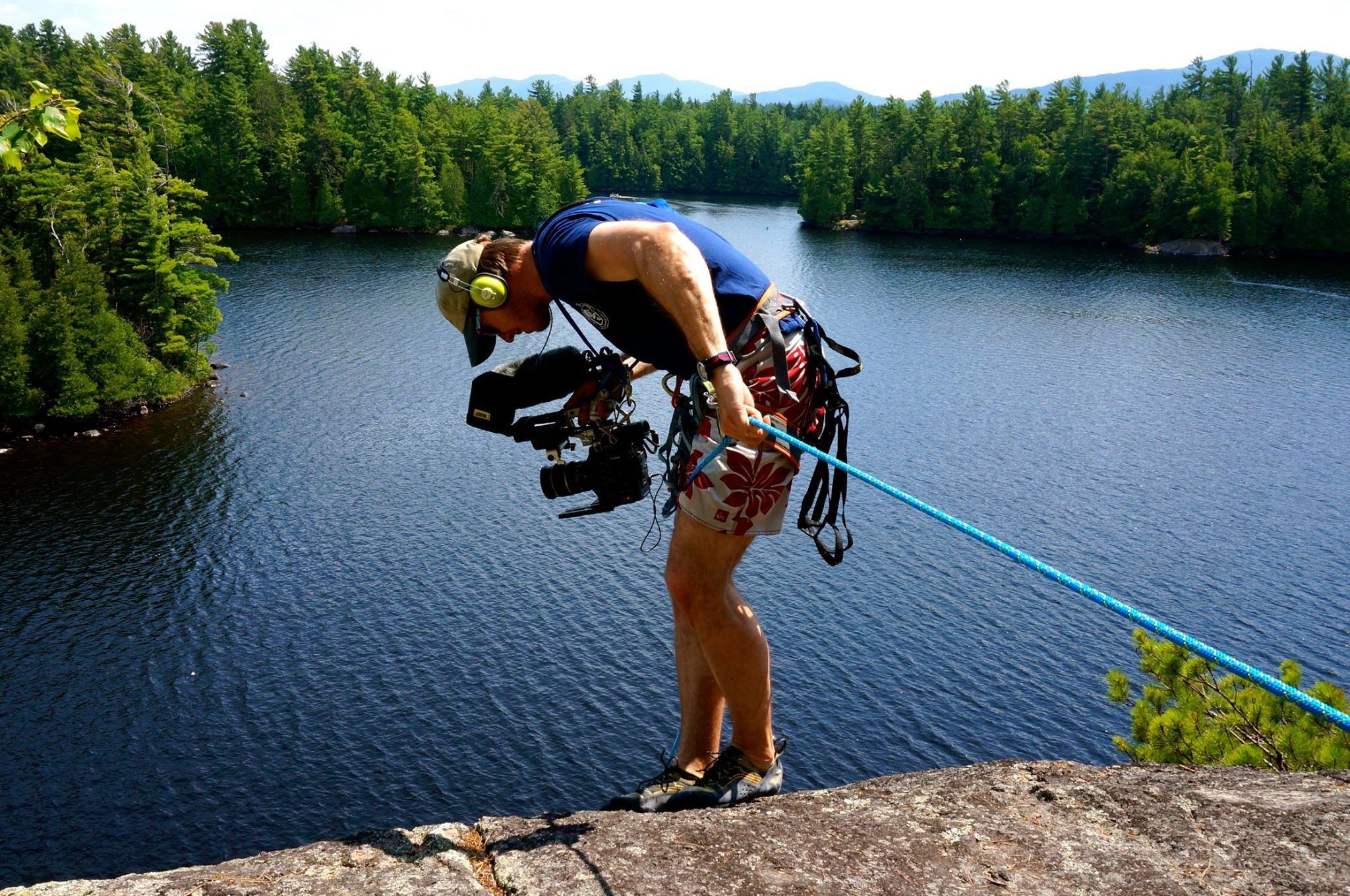 Producer/Editor/DP Rufus Lusk hangs off a cliff in the Adirondack's to capture a camper rock climbing.