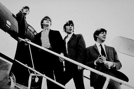 The Beatles (Ringo Starr, John Lennon, George Harrison, and Paul McCartney) boarding a plane, c. 1965