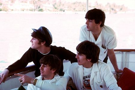 The Beatles, (John Lennon, Ringo Starr, George Harrison, Paul McCartney) on a boat looking overboard,