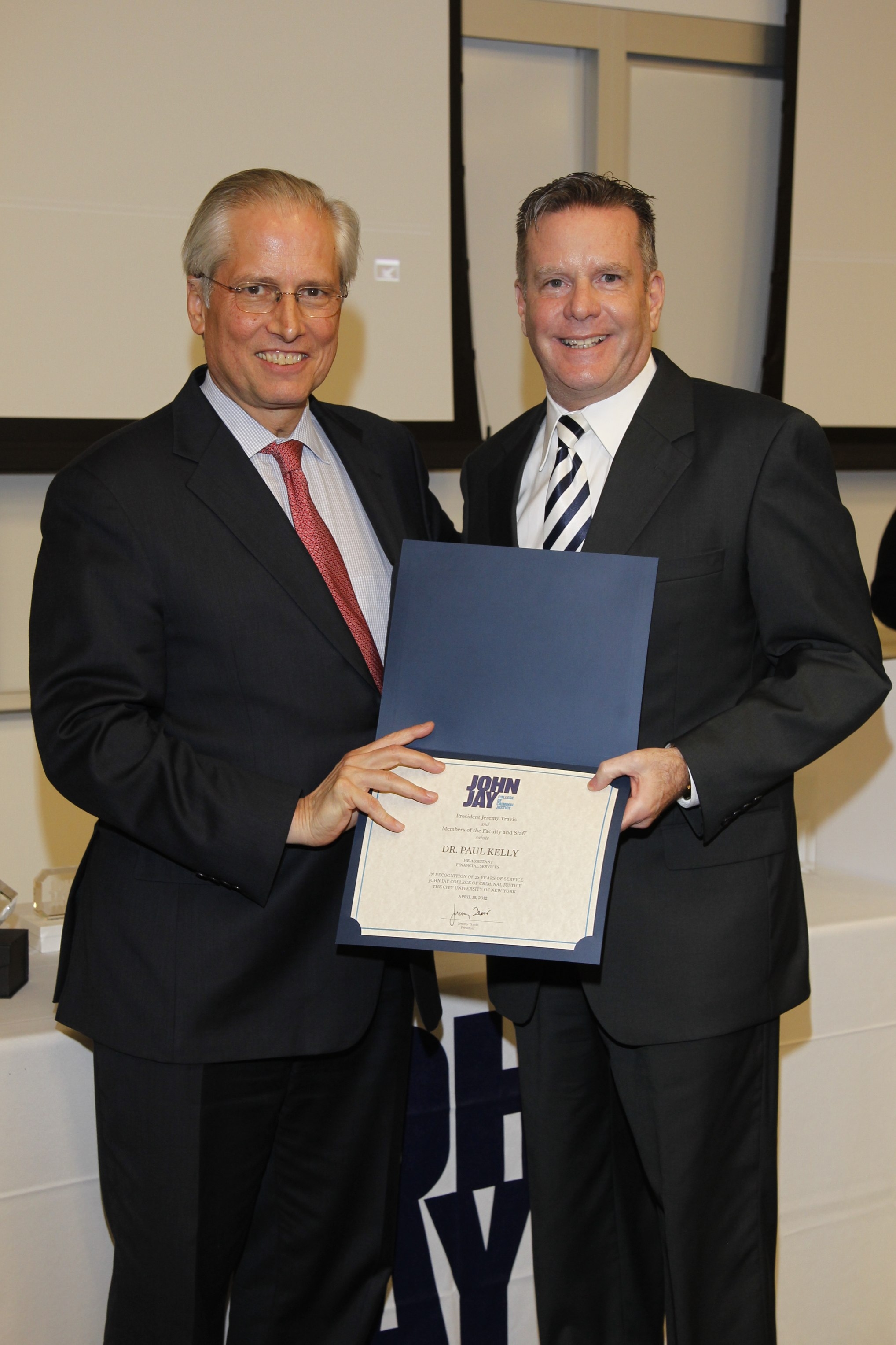 Award for 25 years of administrative service to John Jay College of Criminal Justice, April 18, 2012. President Jeremy Travis and Dr. Paul M. Kelly.