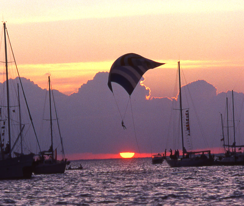 Took this photo at the Columbus Day Regatta on Biscayne Bay. No Photoshop was used, the guy was spinnaker flying as the sun was setting with actually about 1,000 boats anchored out for the night before the race back in the morning.