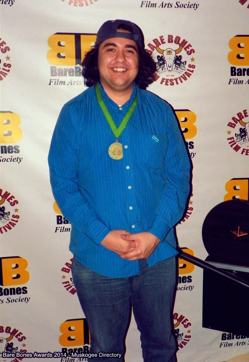 Raj Jawa at 15th Bare Bones International Film & Music Festival in Muskogee, OK wearing the medallion awarded to P.A. for Best Comedy Micro Short.