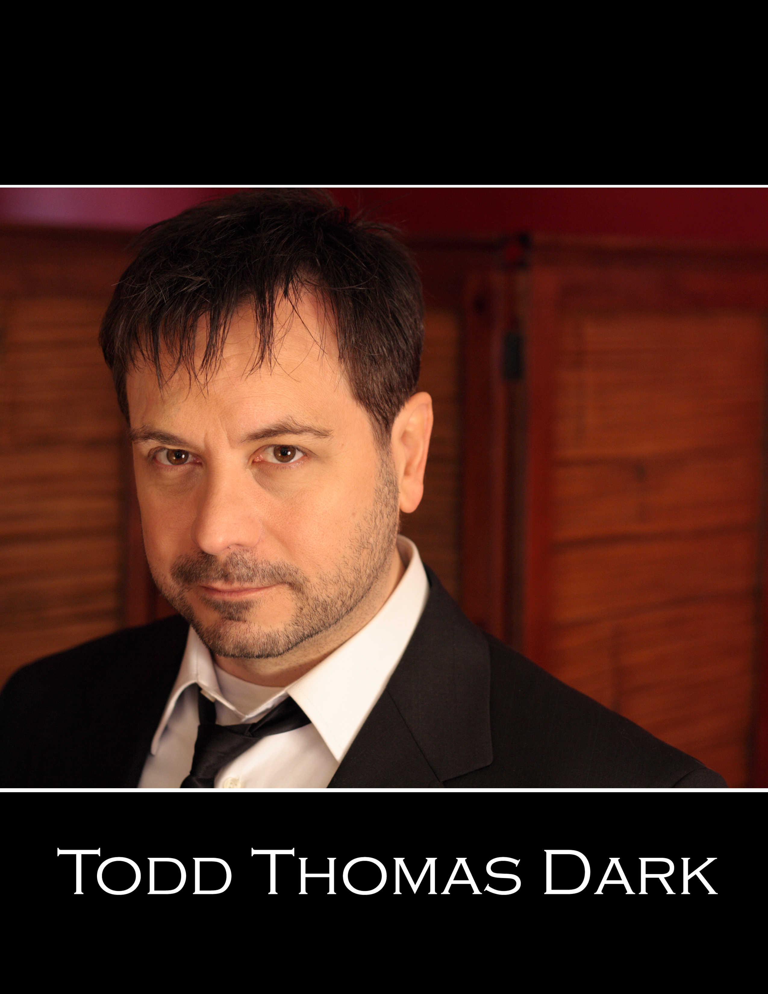 Todd Thomas Dark 2011 headshot loose tie jazz man? reporter? lawyer? detective?
