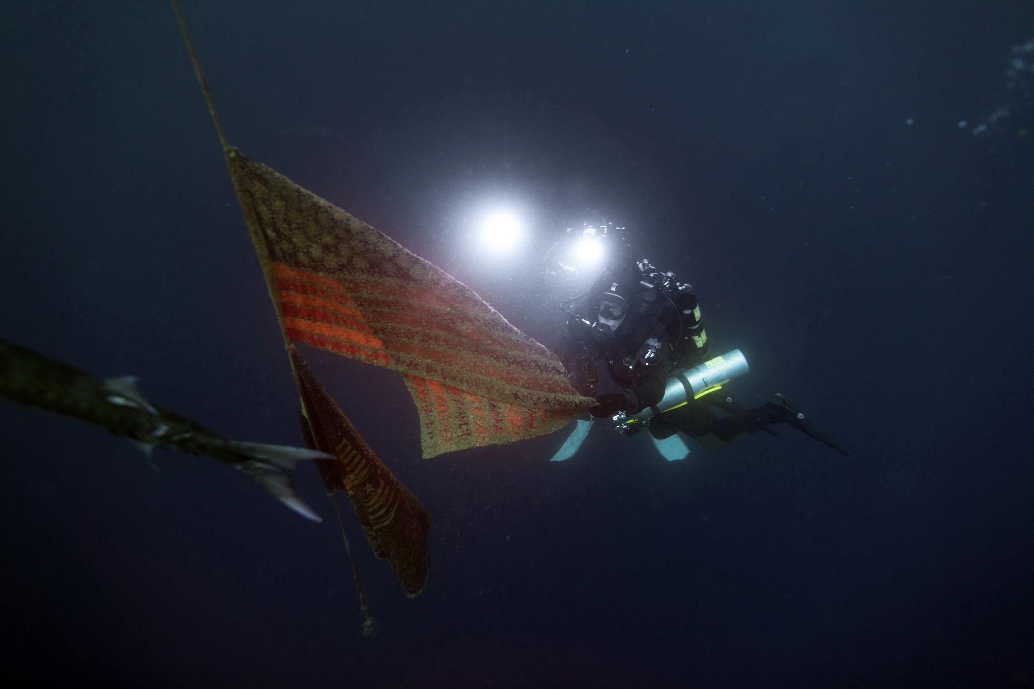 Teddy Smith filming the USS Oriskany at 120 feet underwater.