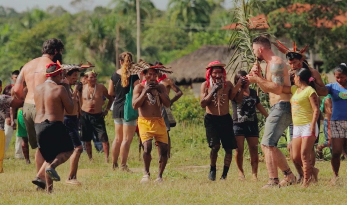 Devan Long getting a flute lesson with his brother Rien in the Amazon.