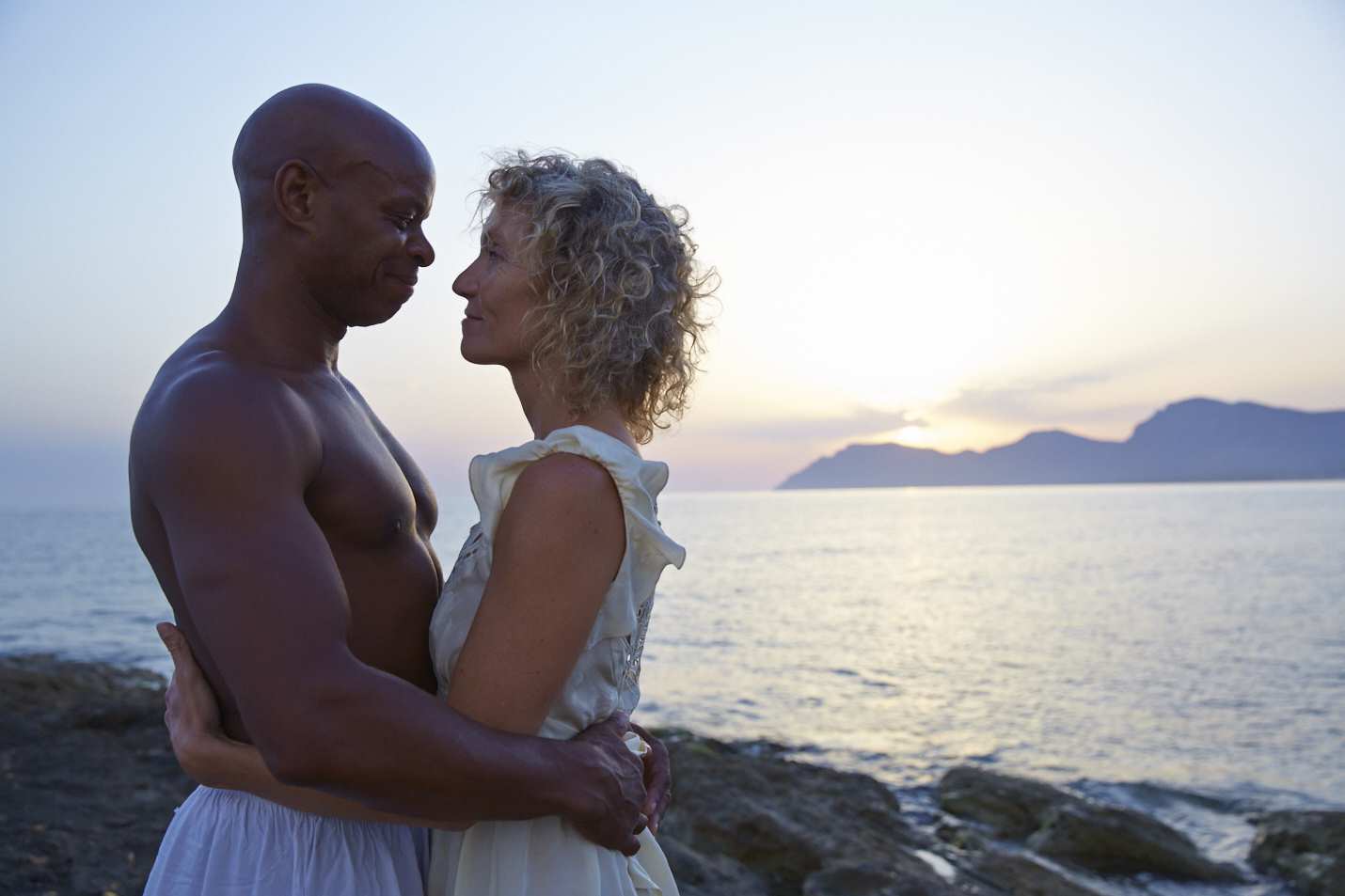 Mixed race couple on the beach. Manuela Stoerzer, Anthony Reid