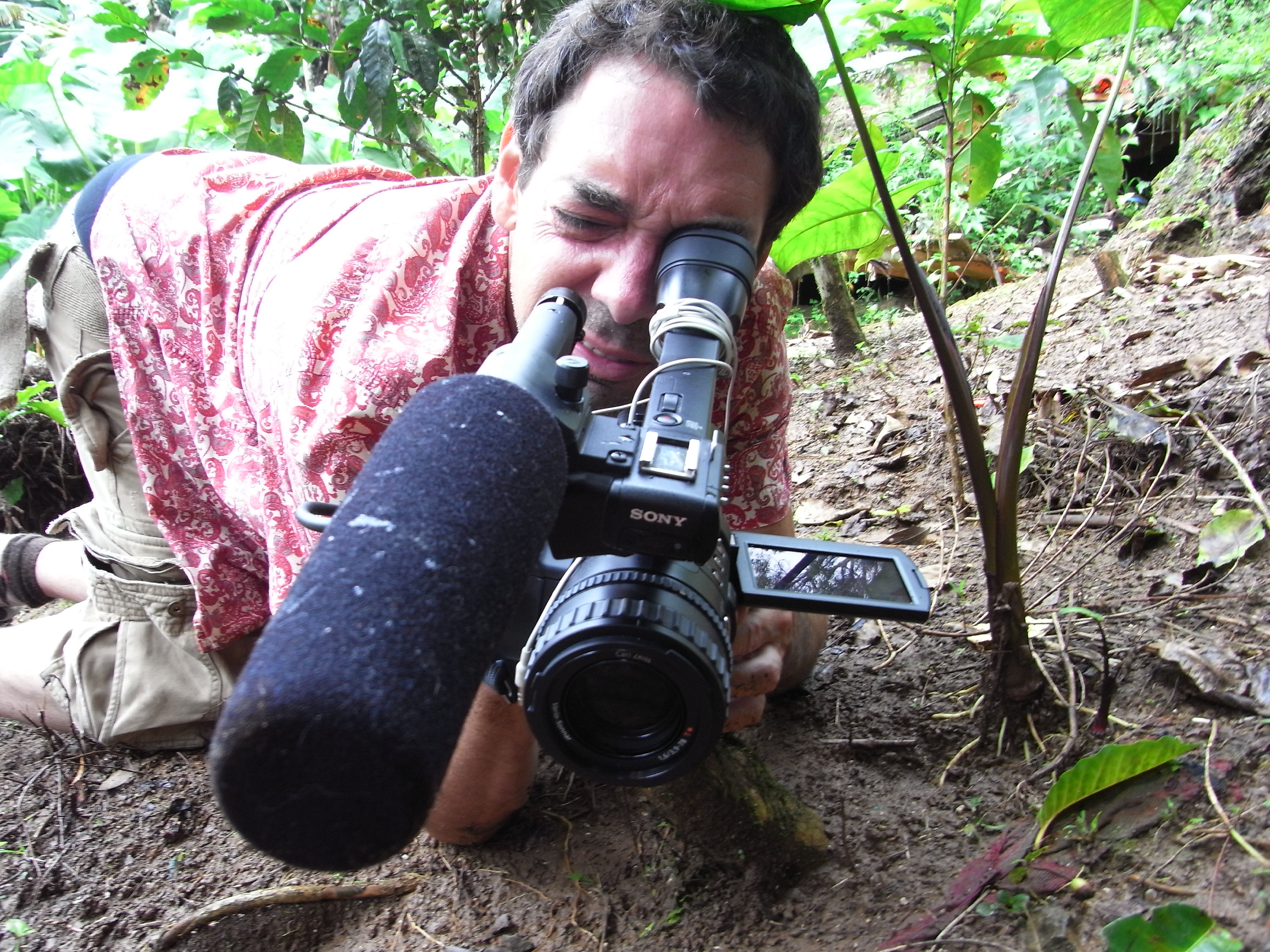 Alex Wolfe framing fallen coffee beans during the production of Last Harvest.