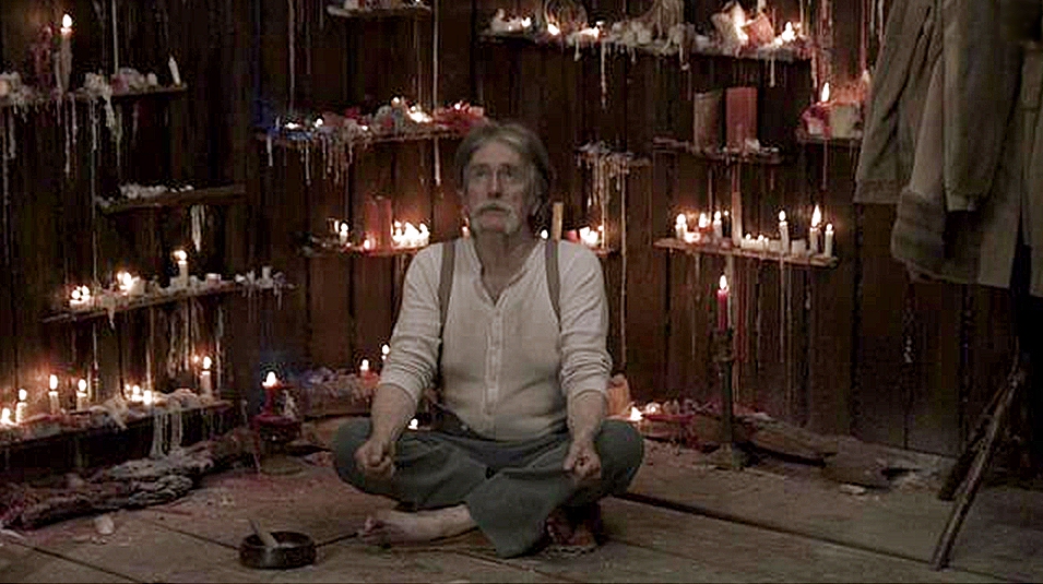 Actor James L. Perry prays that the cabin set does not burn down around him in the Promised Land music video.