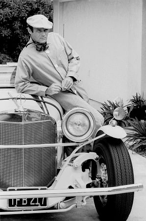 Adam West at home with his Excaliber car, 1966