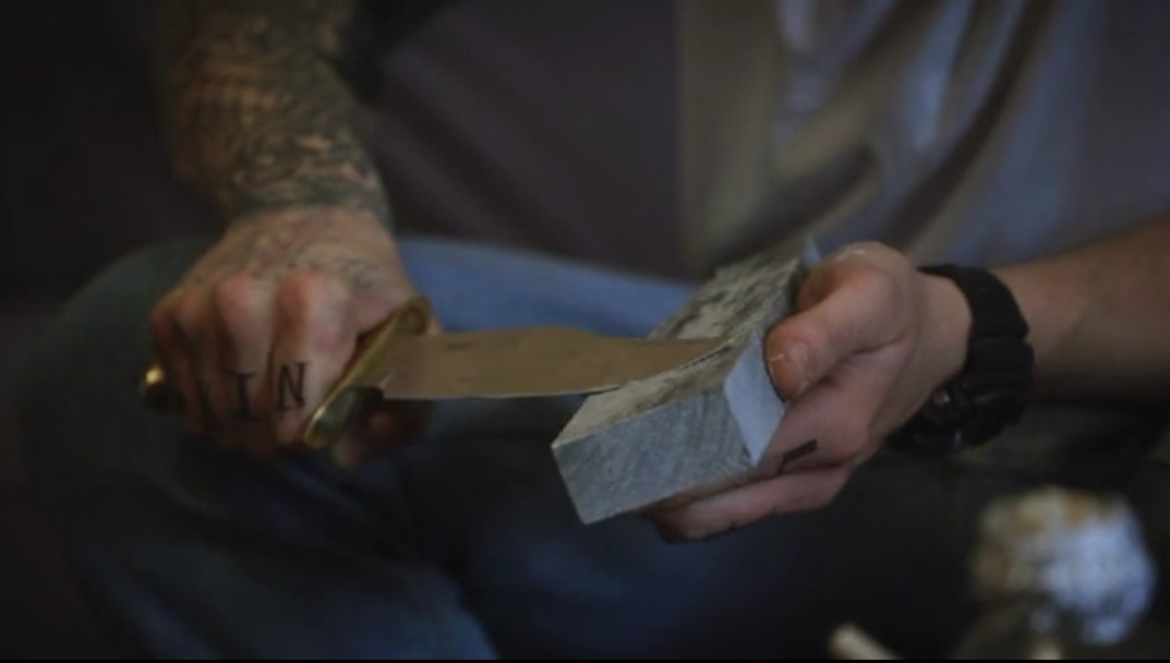 Patrick Brana as Ace sharpening a knife in Straight Outta Tompkins