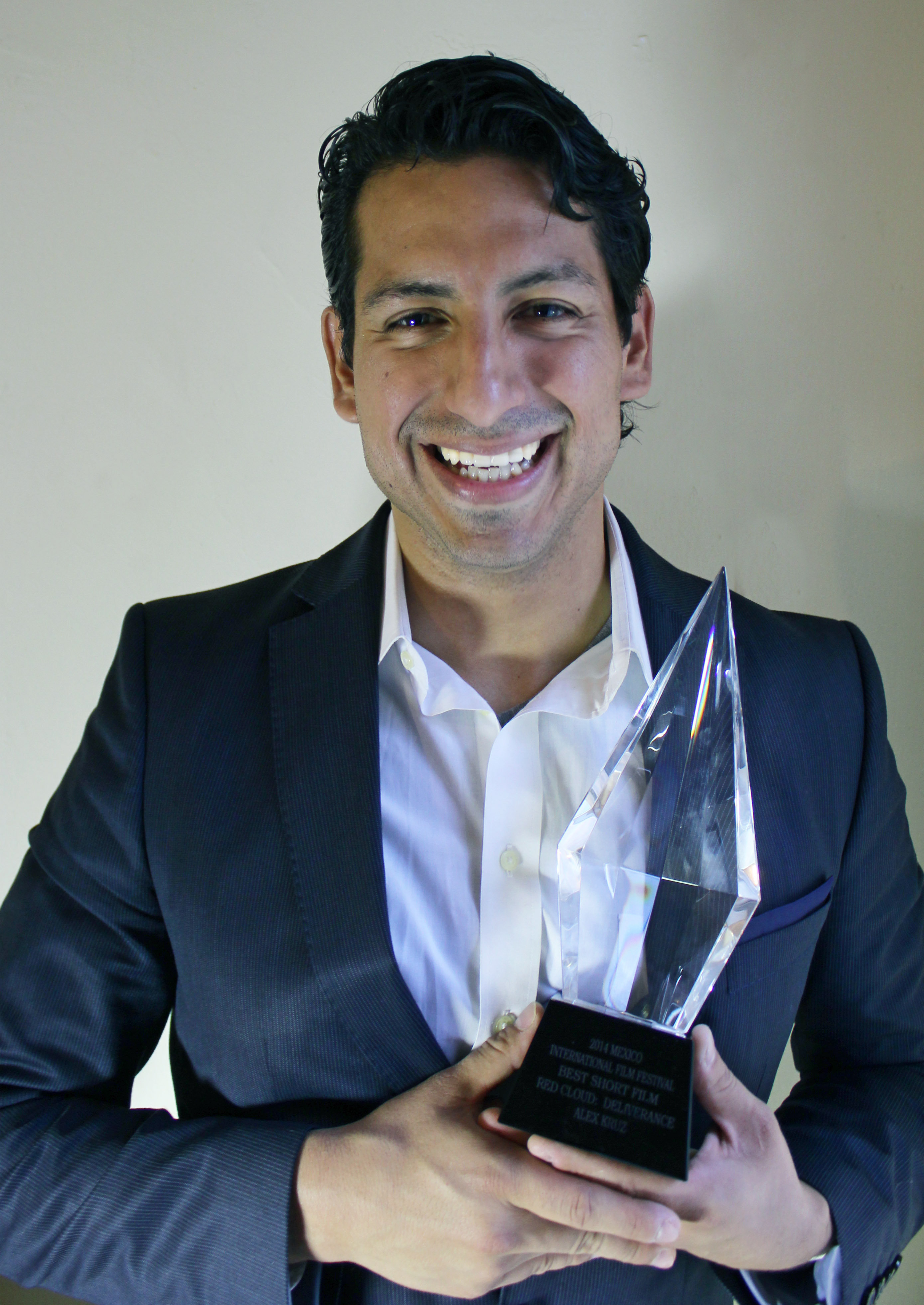 Alex Kruz with the crystal trophy award for the Best Short Film 2014 at MEXICO International Film Festival