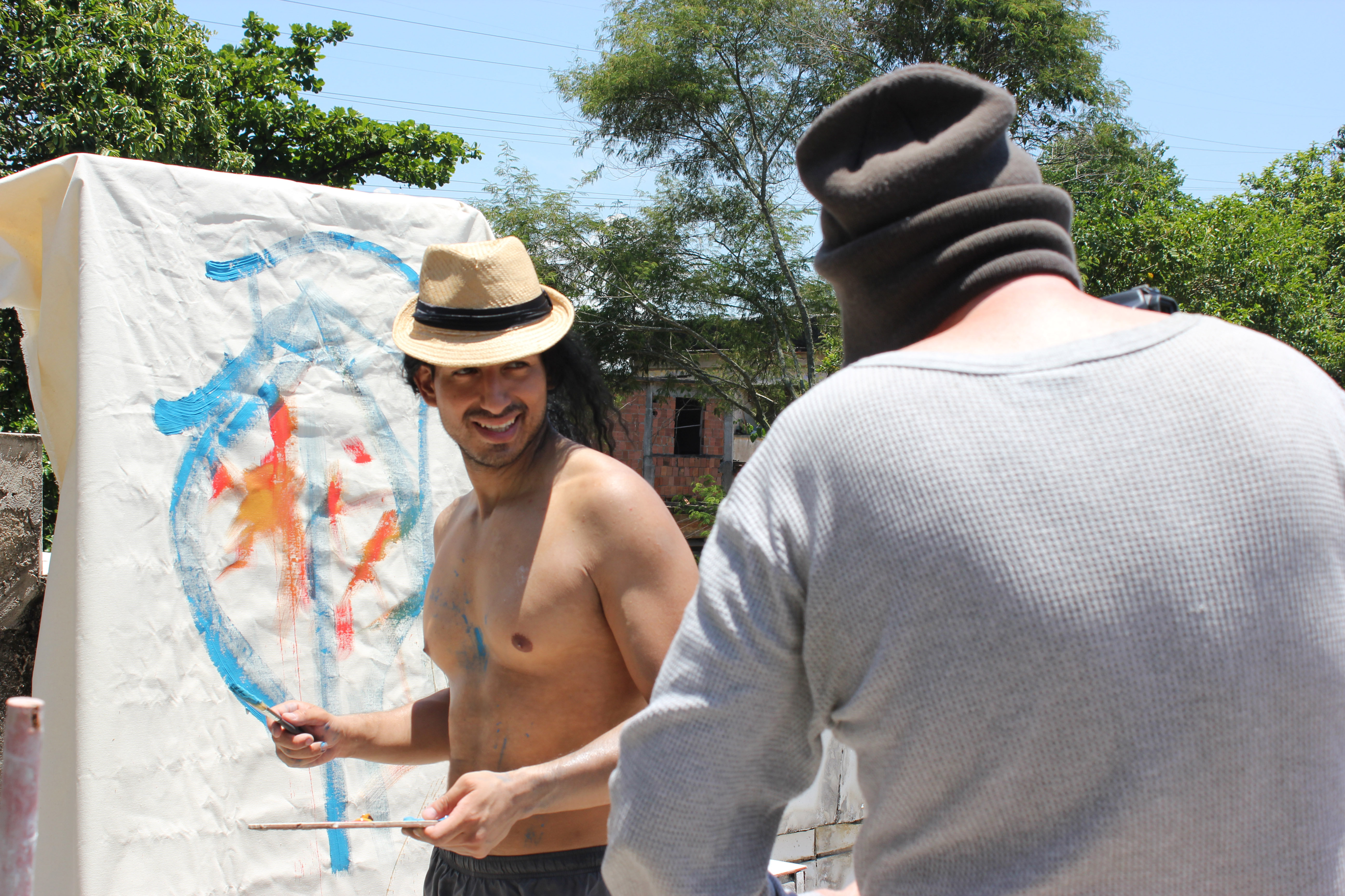 João Freire (Alex Kruz) painting a picture as director Robert J. Johnson contemplates camera angles to match story.