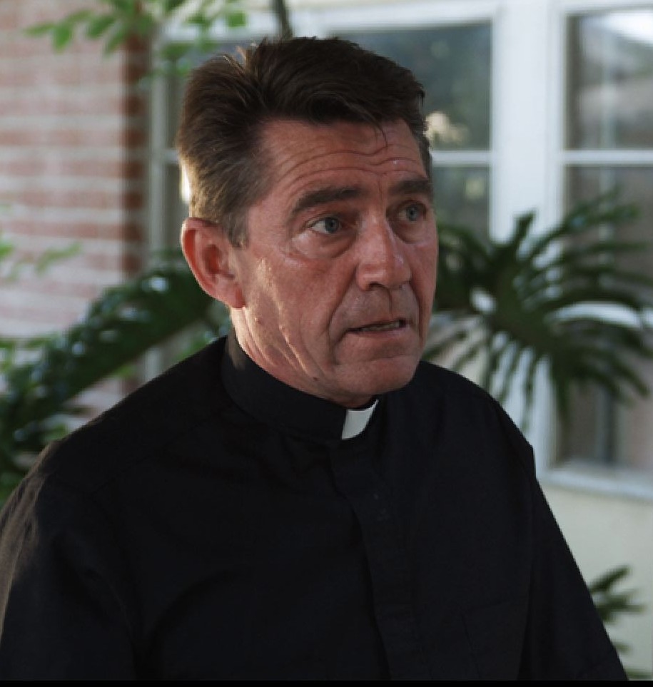 Anthony B. Cohen as The Priest in 