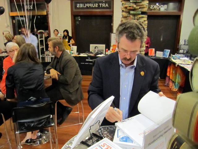 Signing a copy of 