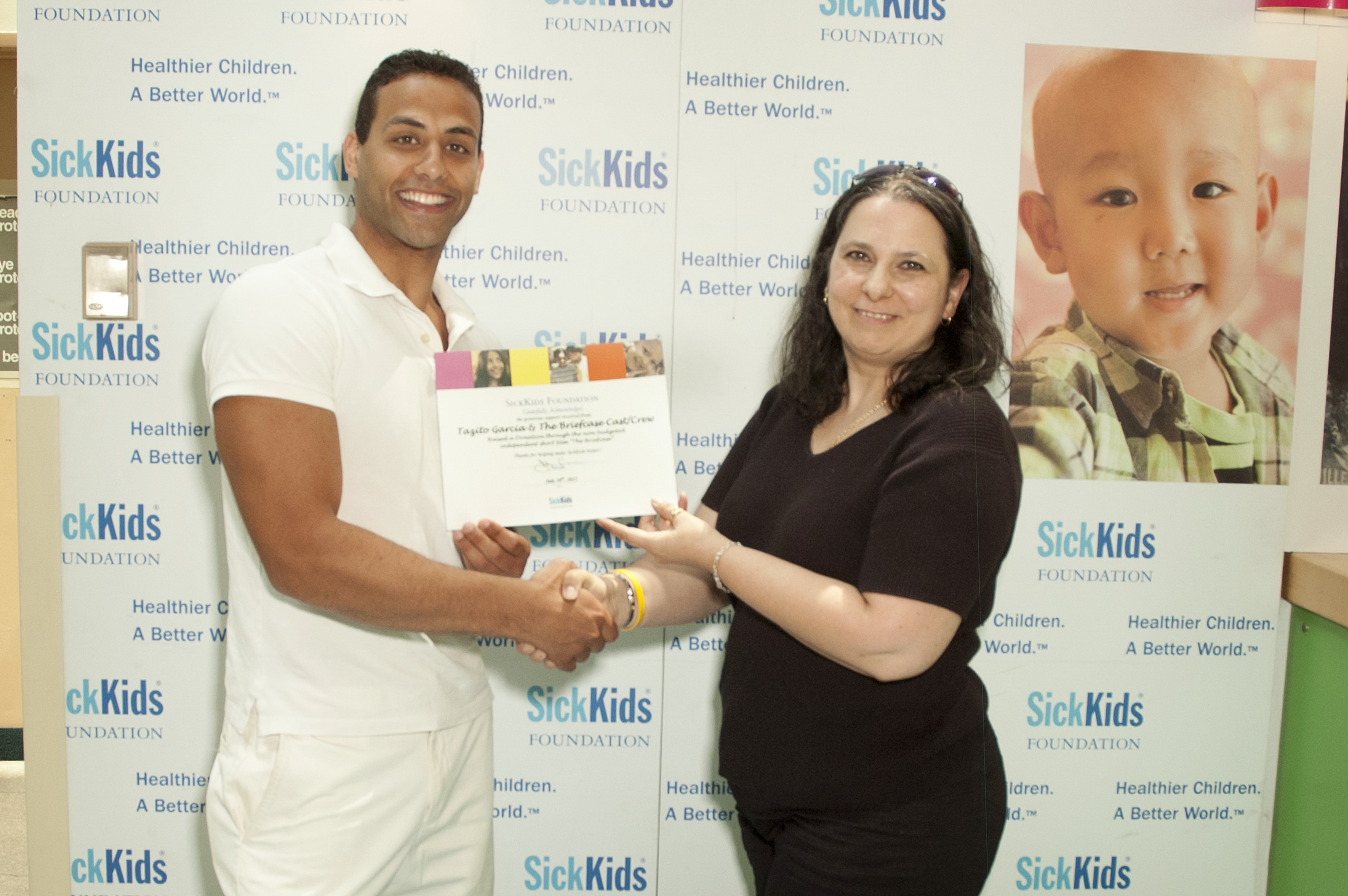 Tazito Receives a thank you certificate for his donation on behalf of himself, and THE BRIEFCASE CAST/CREW to the 'URGENT CARE UNIT' at the SICK KIDS HOSPITAL in Toronto, Canada