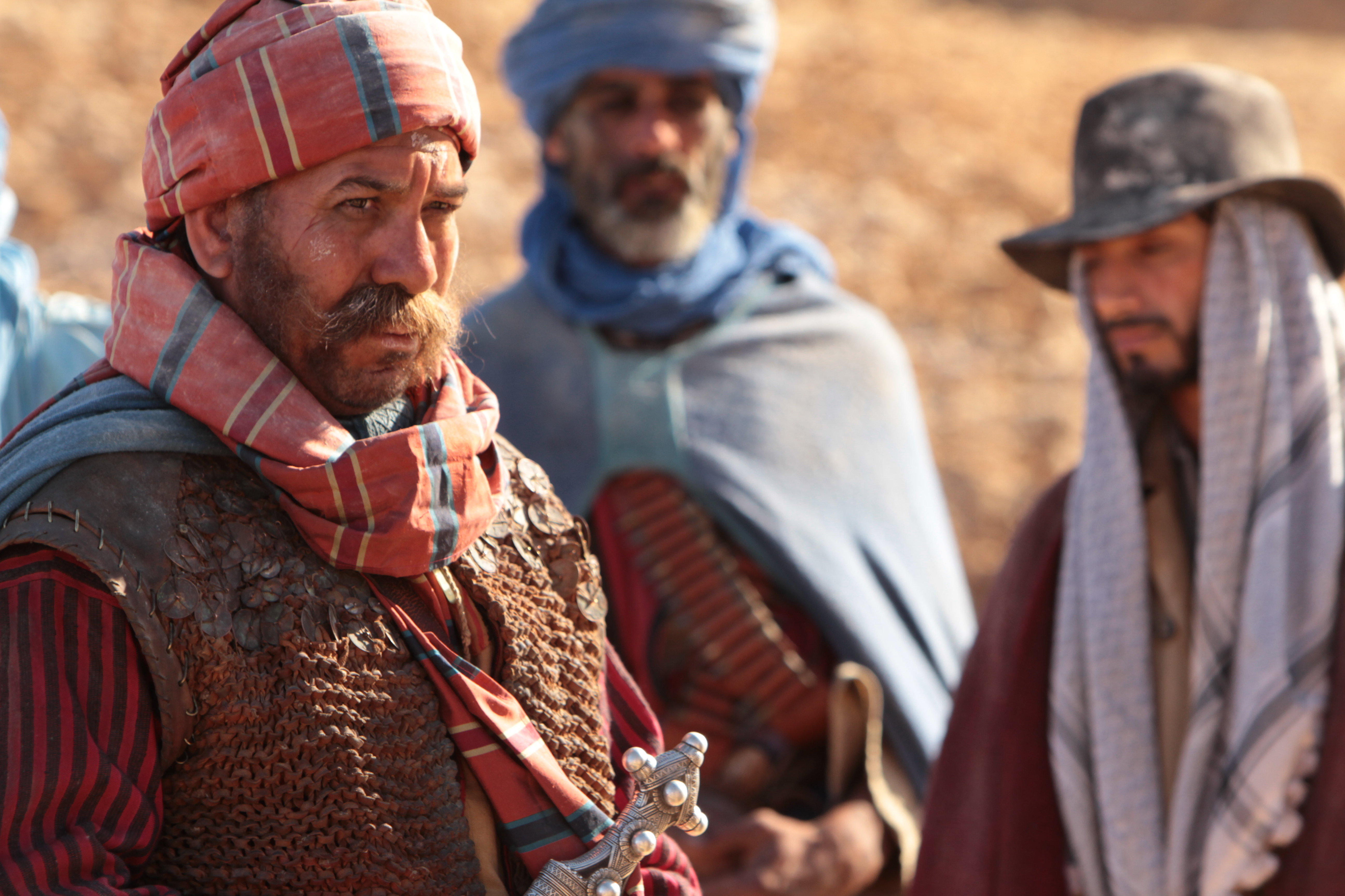 Magrouf (Driss Roukhe) with Ali (Riz Ahmed) and other tribes men