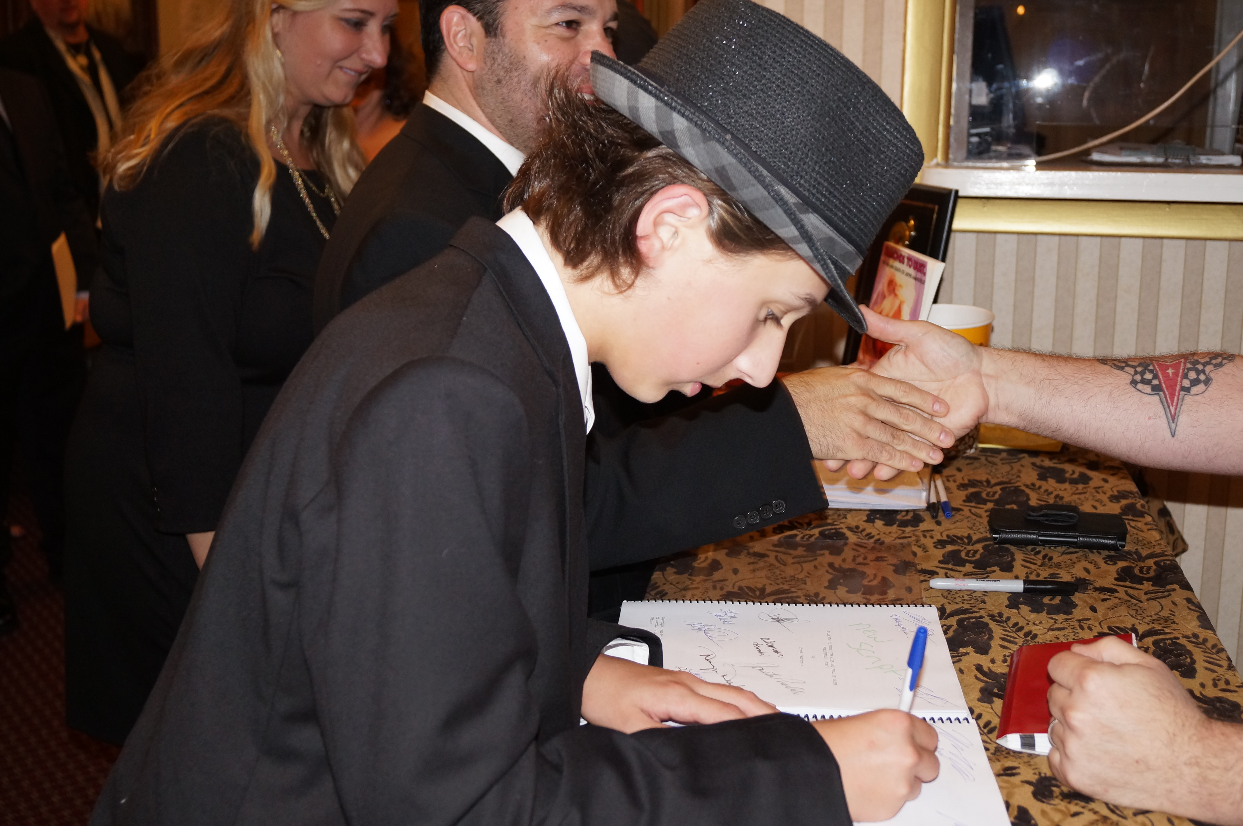 Brady Bryson signing copies of the script for auction after the premiere of 