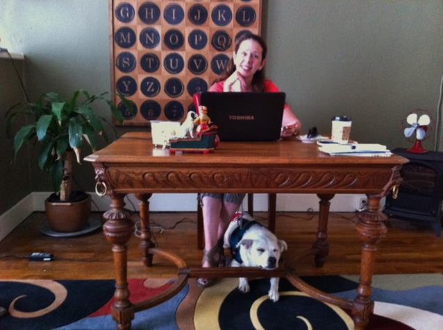 Susannah Charleson at her writing desk with Jake Piper resting his chin.