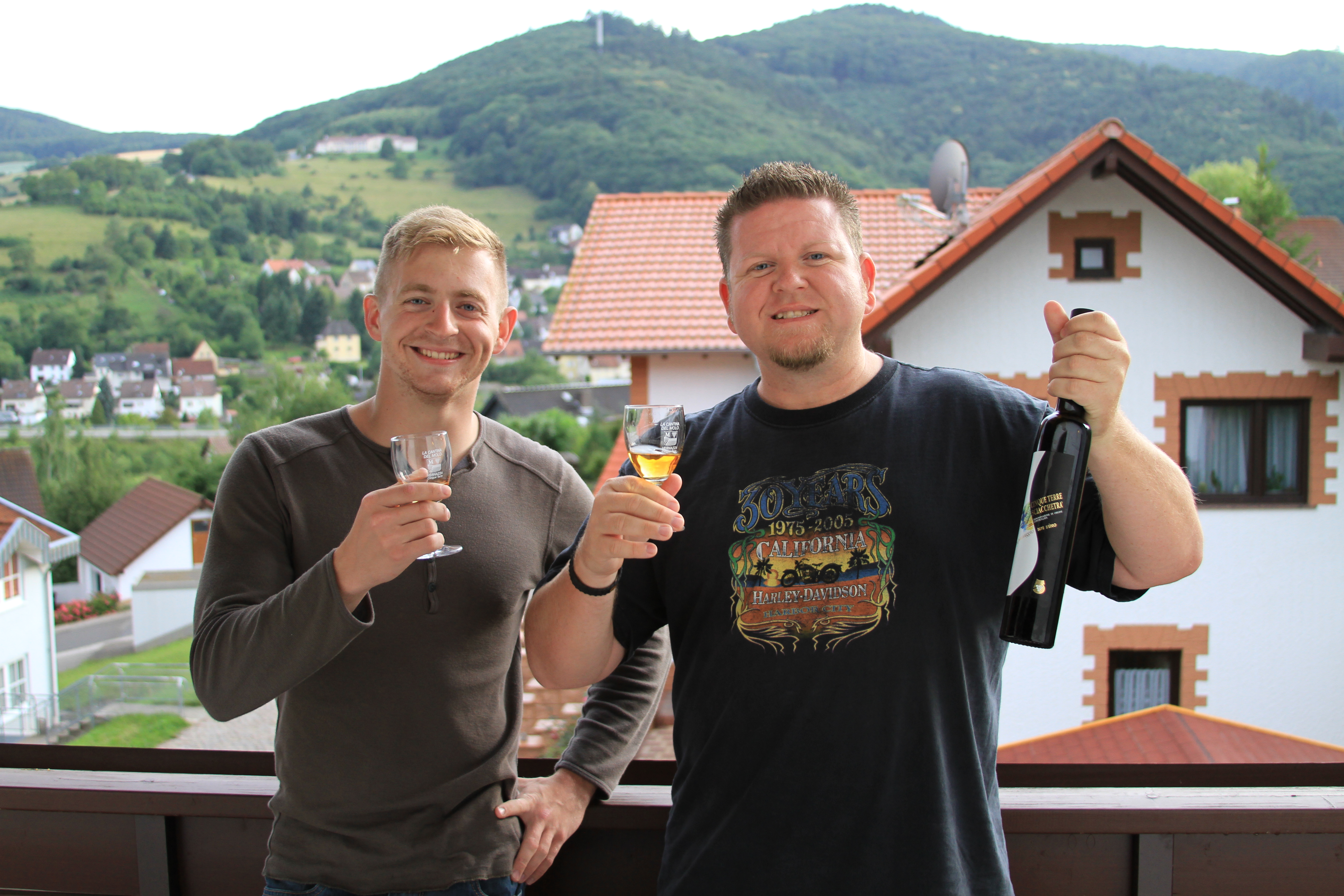 Larry A. Burns Jr. and Christopher Dearborn drinking Sciacchetra' on Larry's balcony in Germany.