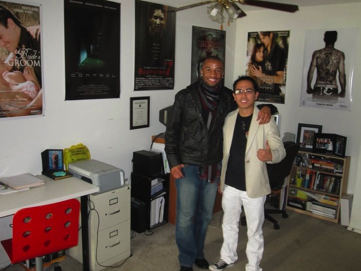 Rey and writer/director Justin Chambers, with his previous films on the wall