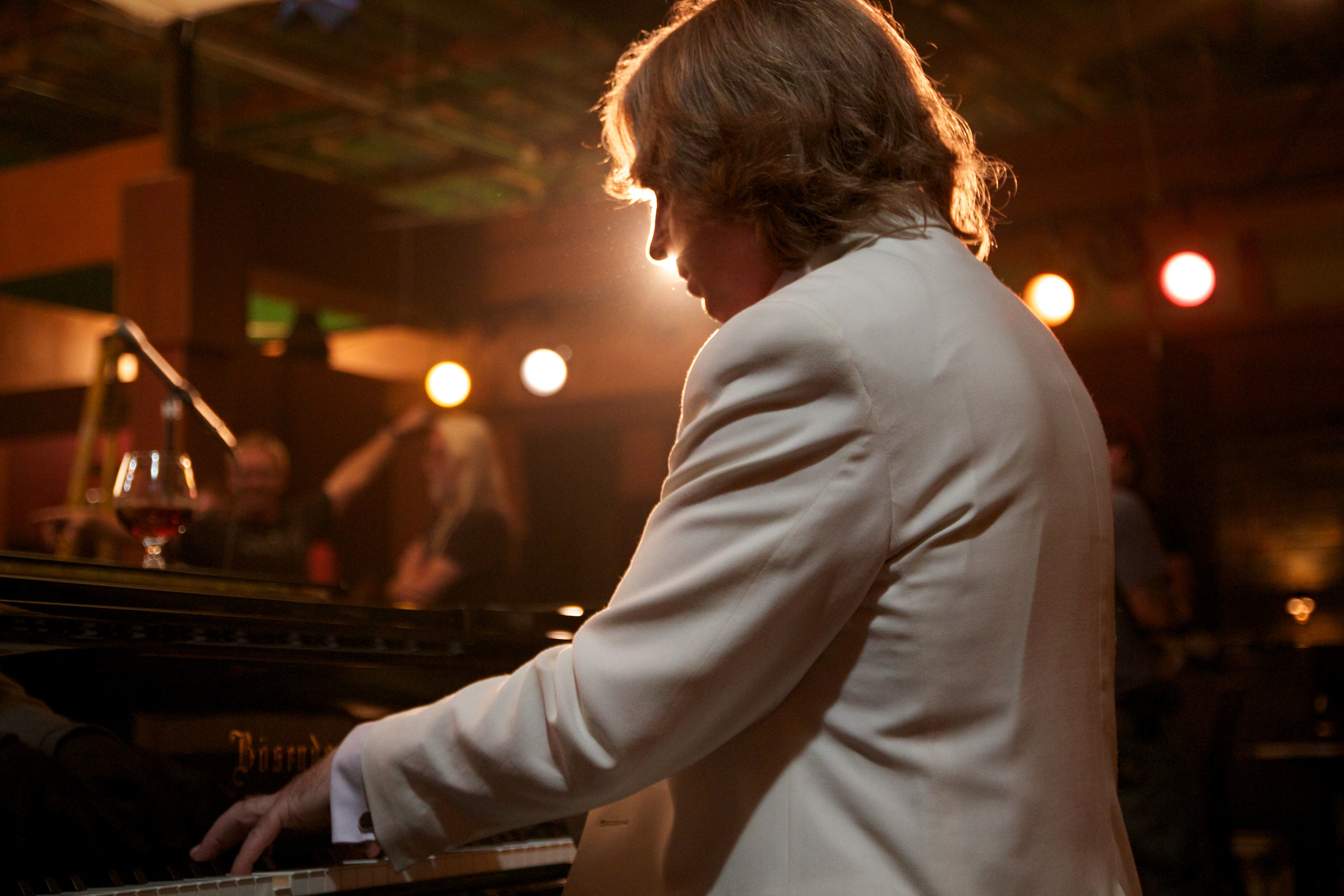 Jack Holmes at the piano on the set of 
