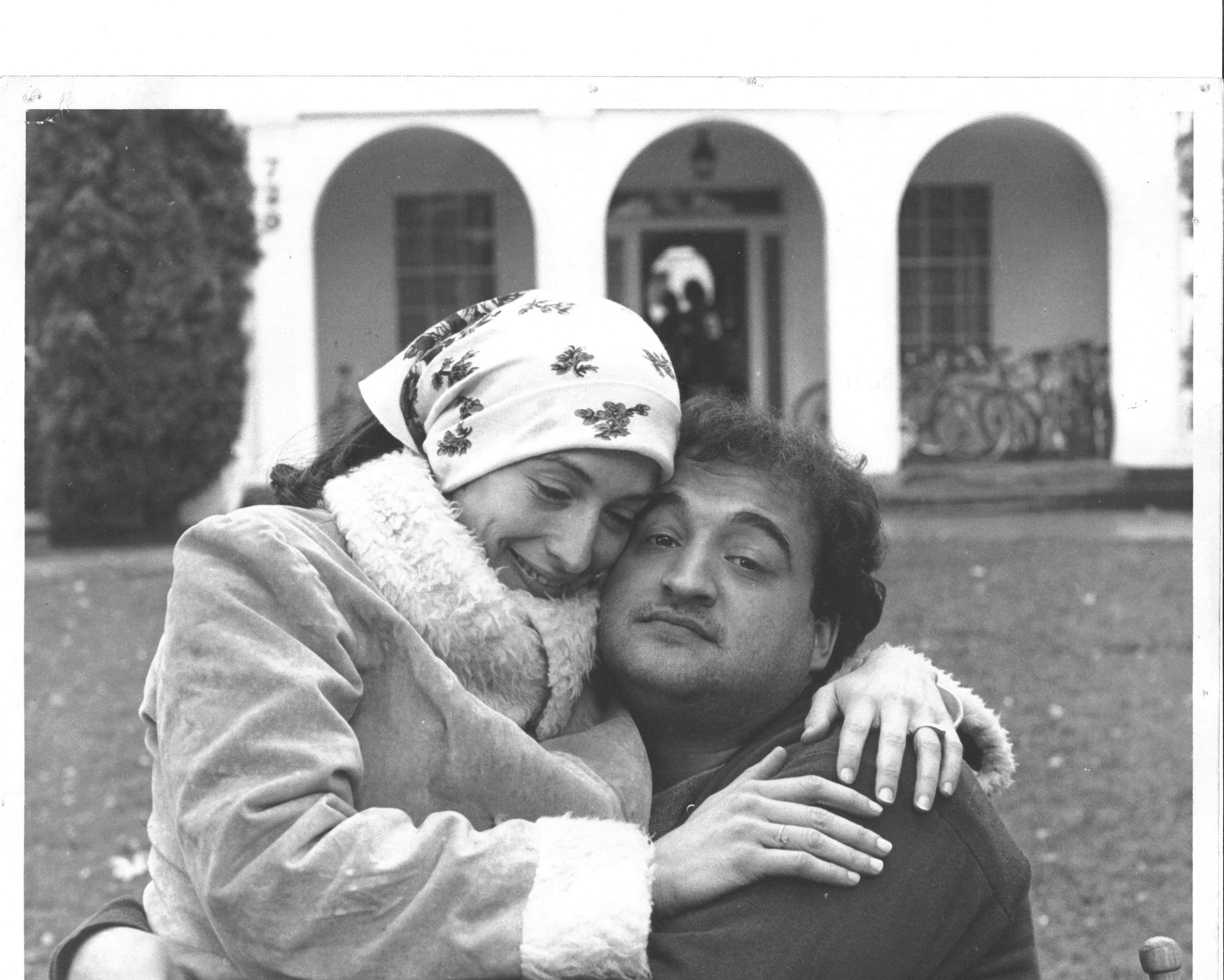 Katherine and John Belushi on the set of 