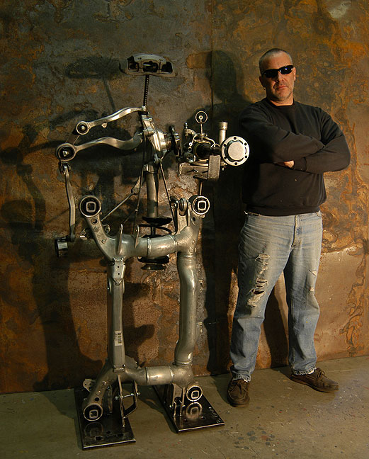 Sculptor Bruce Gray with his Robot sculpture made from a crashed BMW.