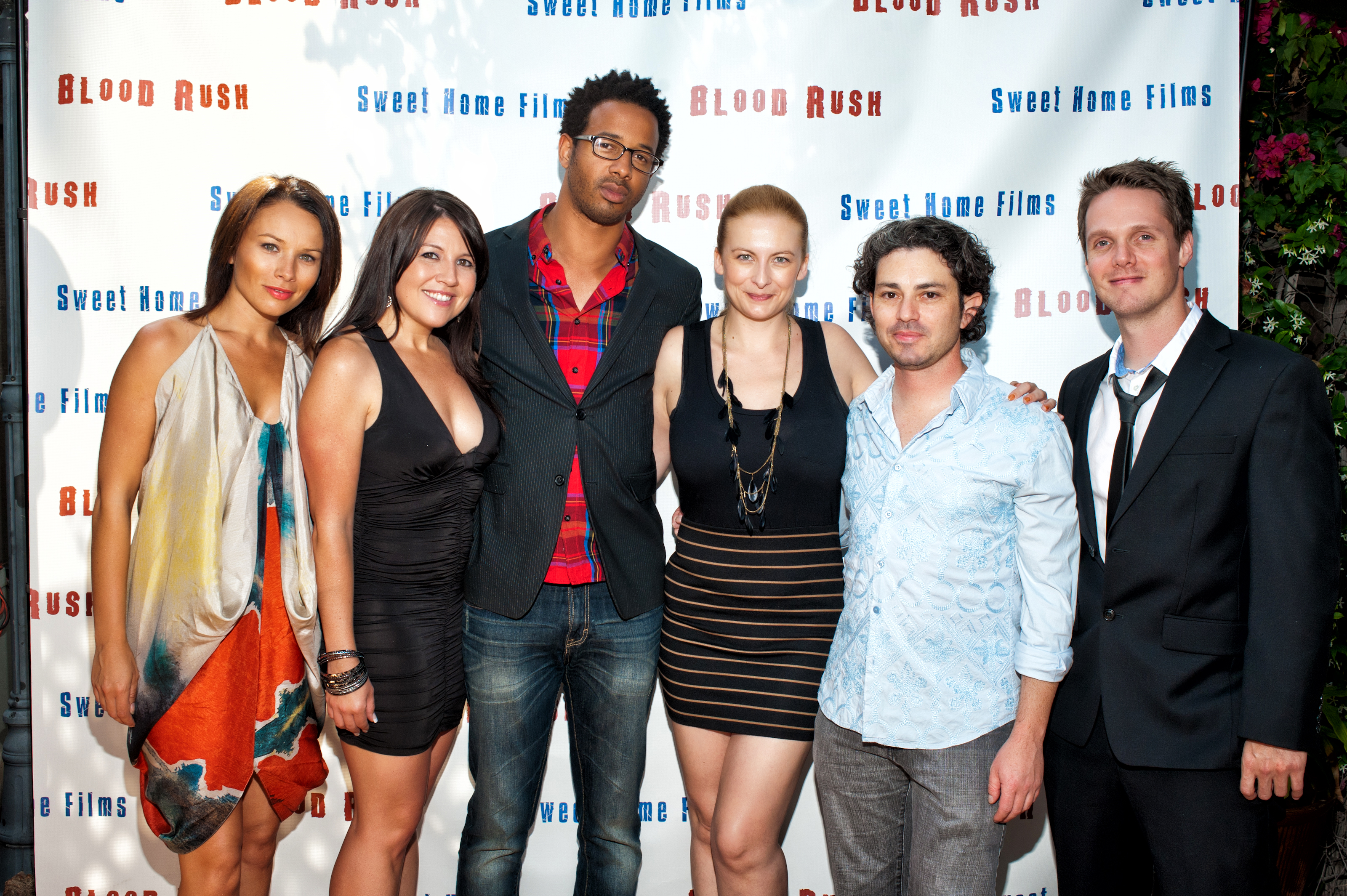 The cast and crew of Blood Rush, doing the step and repeat.