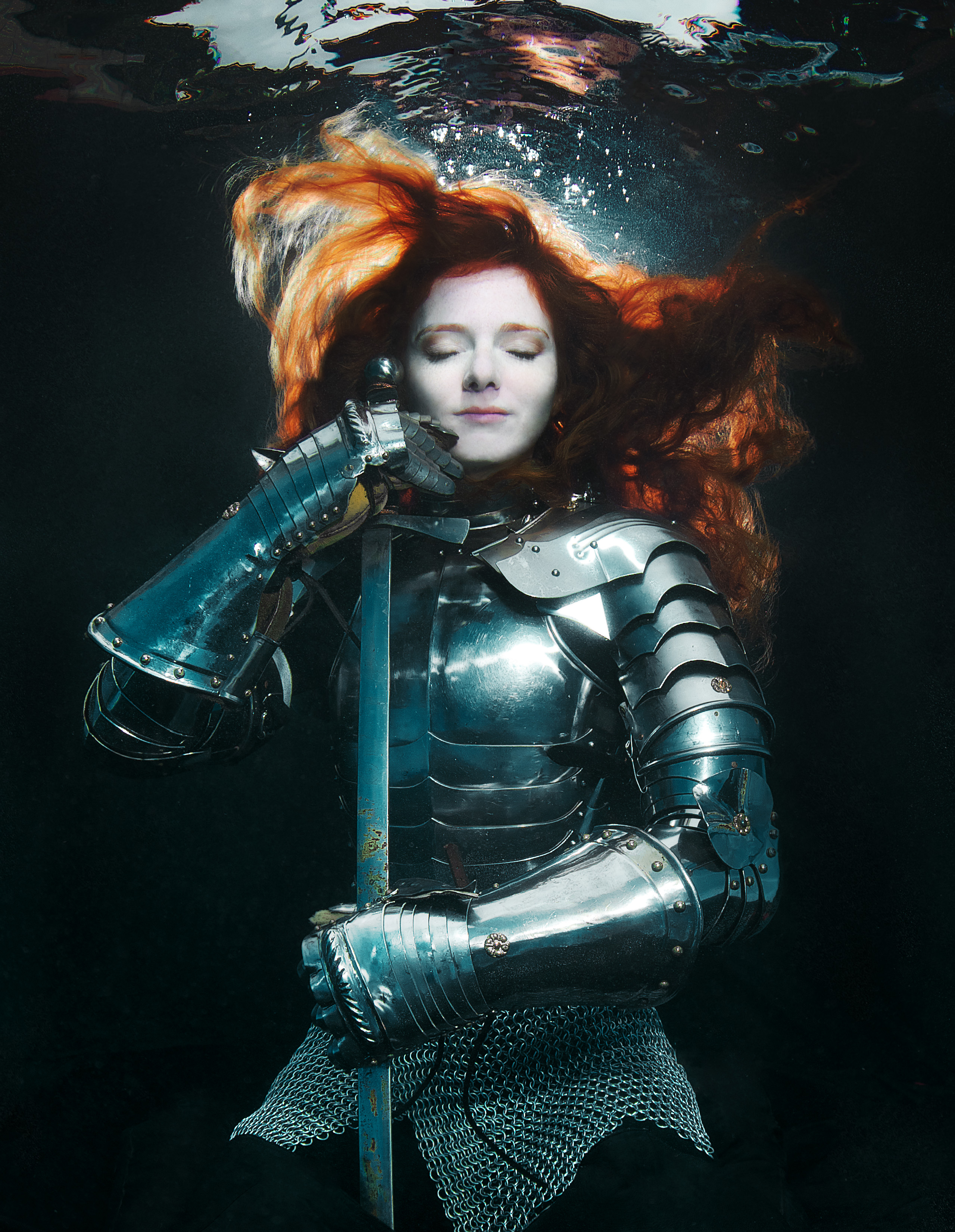 PADI-certified diver Virginia Hankins modeling underwater in armor