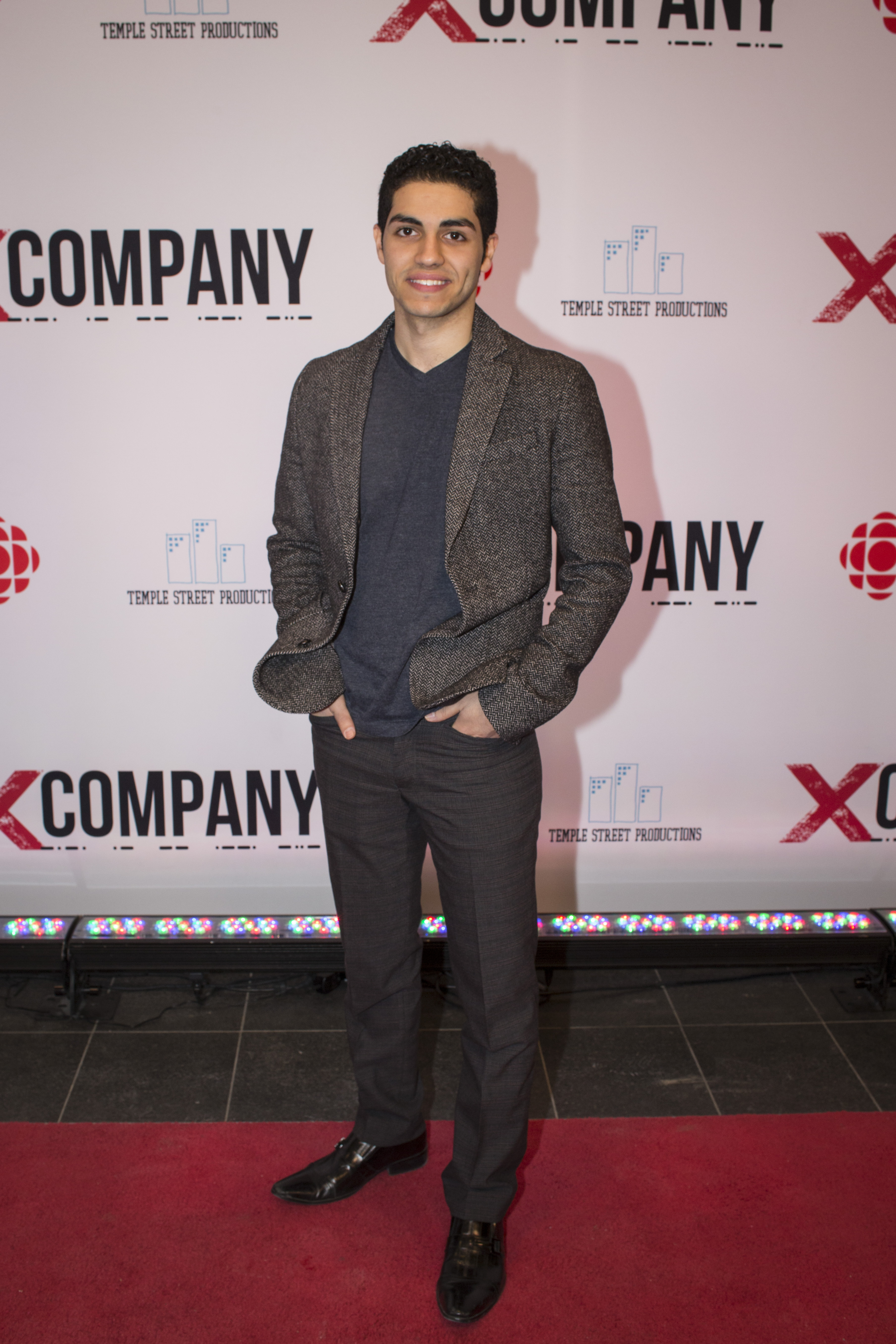 Mena Massoud attends the X Company red carpet premiere.