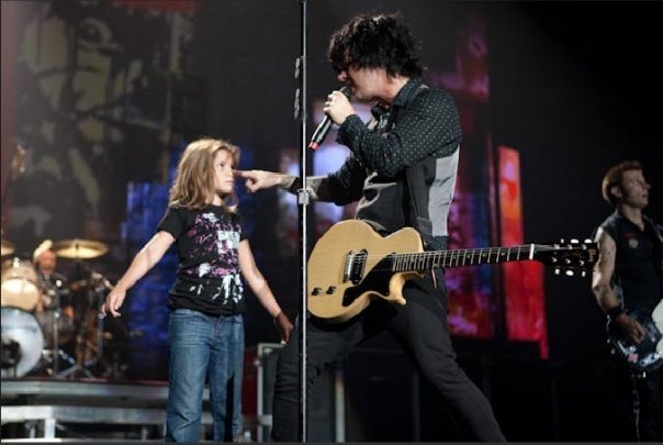 Alyssa doing a skit on stage with Billy Joe during a Green Day concert.