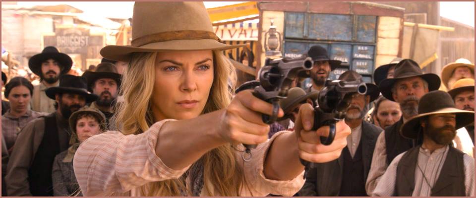 On left of Charlize Theron in A Million Ways to Die in the West.