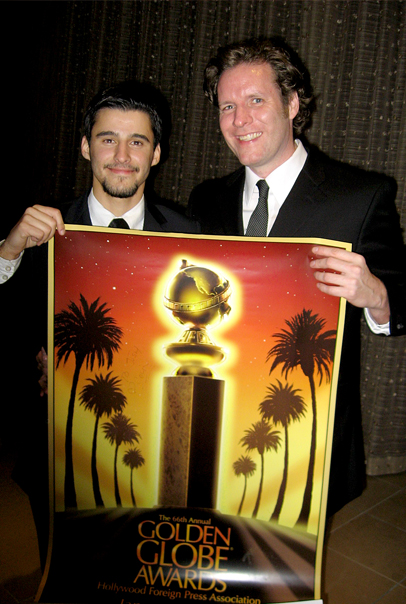 (L-R) Producer Josh Wood and artist Colin McGreal hold signed poster during a candid moment at the 66th Annual Golden Globe Awards held at the Beverly Hilton Hotel on January 11, 2009.