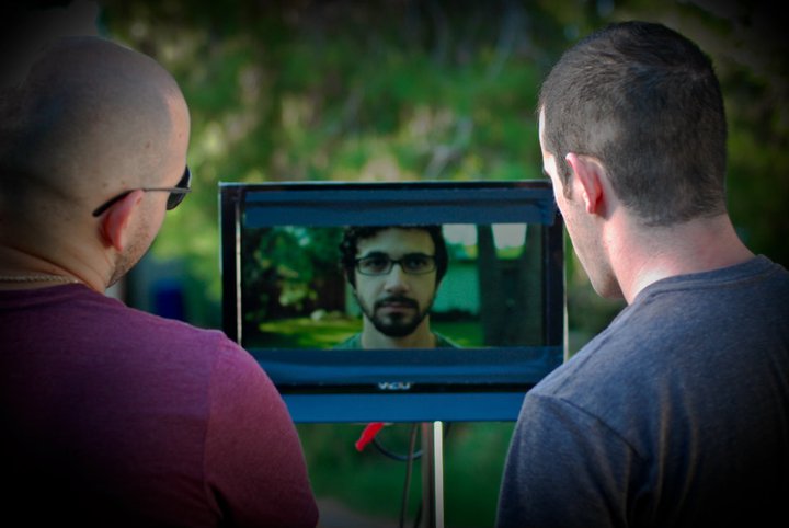 On set, the director and cinematographer observe, the short film 