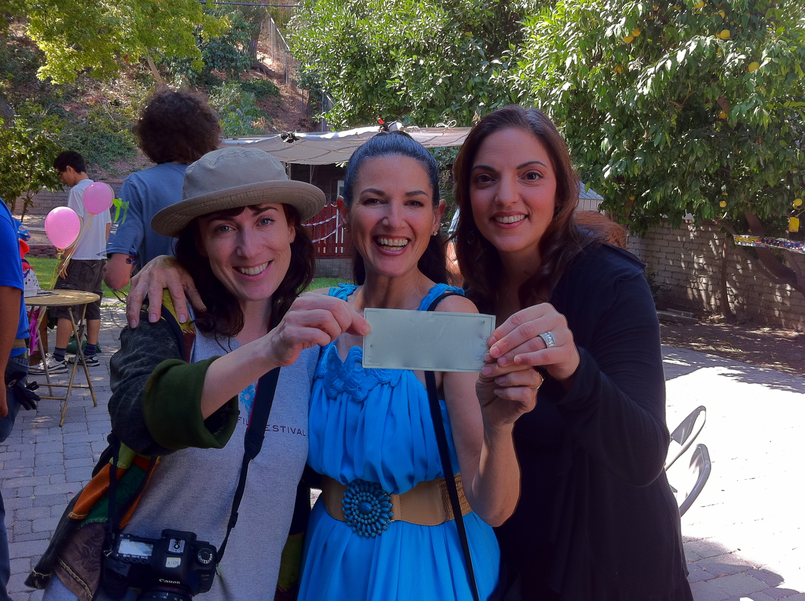 Executive Producer, Sharon A. Fox (in the middle)on the set of ODD BRODSKY with Director Cindy Baer to the left and producer Thomai Hatsios at the right holding up the big check Sharon wrote towards the production.