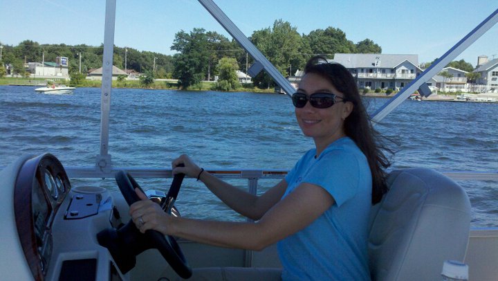 Katina enjoying some rare downtime and doing a little boating.
