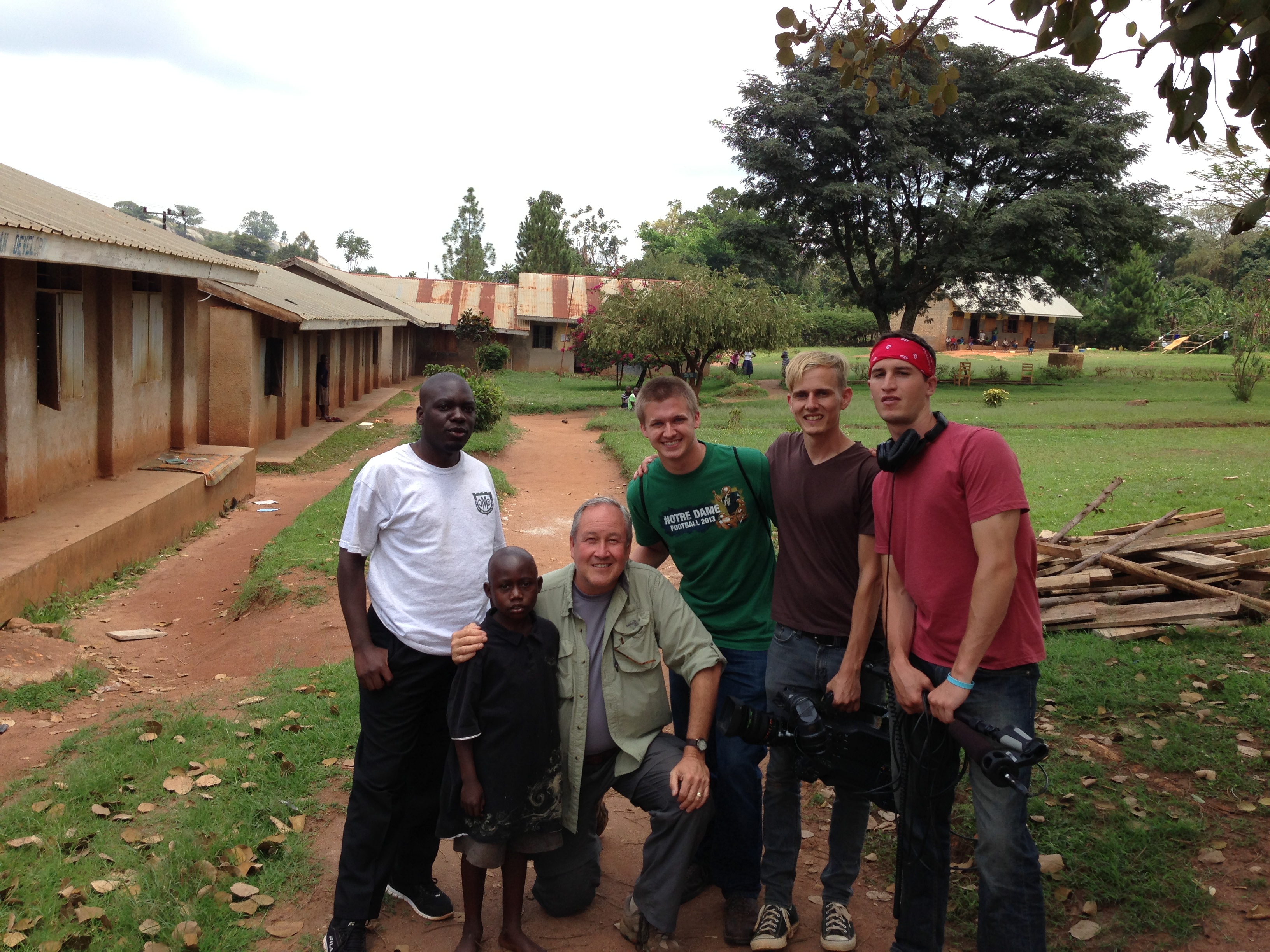 Road to Hope film crew posing with our leading documentary film character, George, at his school in Kakumiro, Uganda.
