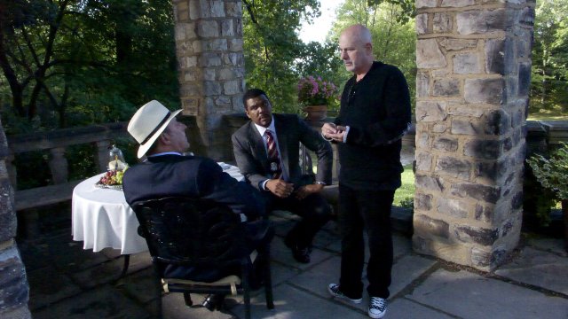on location with director Rob Cohen giving direction to Jean Reno(Mercier)as Tyler Perry(Alex Cross) looks on,in Akron,Ohio at Hewet Hall and Gardens.