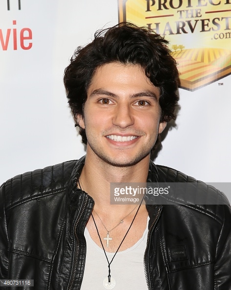 George Kosturos on the red carpet at the premiere of 