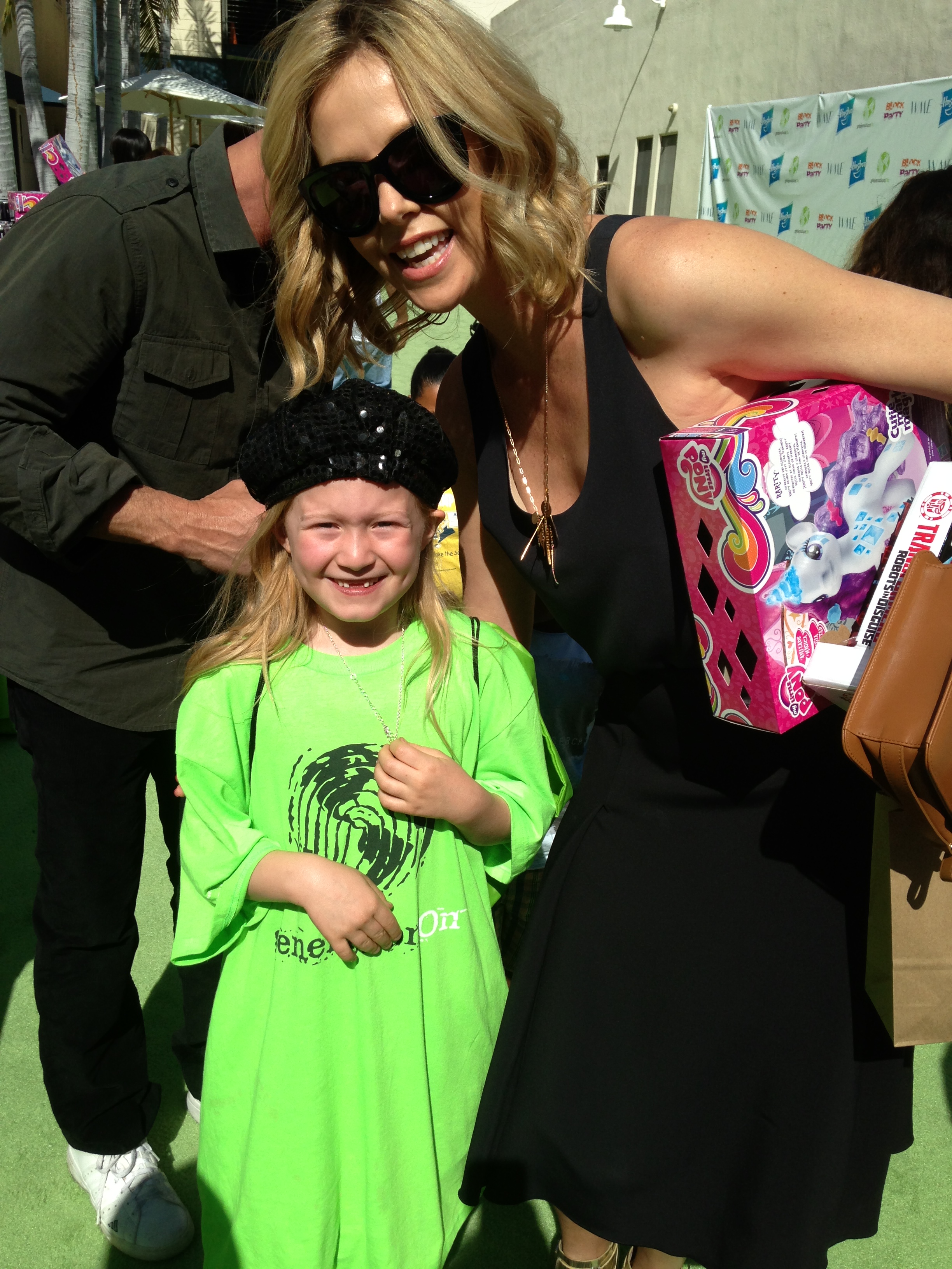Actress Abigail Zoe Lewis meets Charlize Theron at the Points of Light generationOn Block Party on April 18, 2015 in Los Angeles, California.
