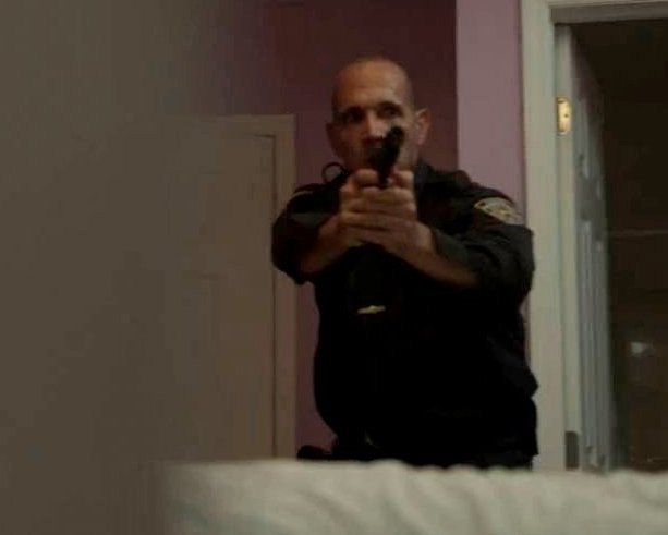 Screen capture of Gilbrando Acevedo, as Officer Ortiz, in Bottle in The Smoke.